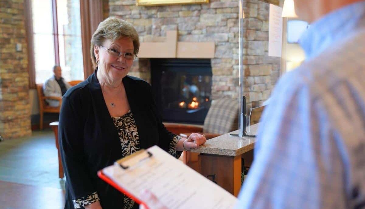 Hematology-oncology-associates-of-fredericksburg-why-choose-us-cta (1) Woman standing at the front desk