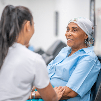 Hematology oncology nurse comforting a female cancer patient