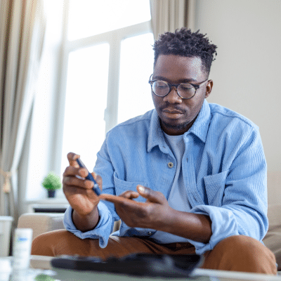 Man pricking his finger for a blood sample, representing common blood disorders
