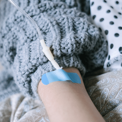 Iv in a person's arm, representing chemotherapy
