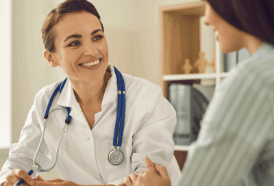 A doctor talking to a patient, representing first visit to a hematology oncologist