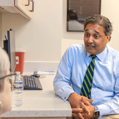 Doctor in a tie sitting and talking to a patient, representing lymphoma diagnosis