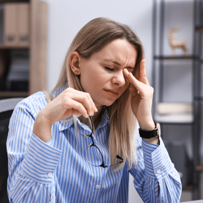 Woman experiencing fatigue in the office, representing when to see a doctor for anemia symptoms